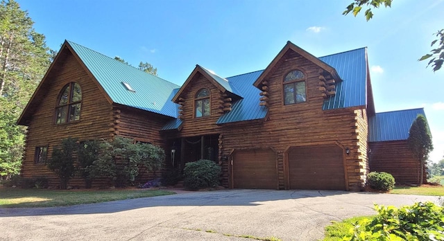 W6887 Two Mile Rd, Porterfield, WI 54159 - log-style house featuring log siding, metal roof, driveway, and an attached garage