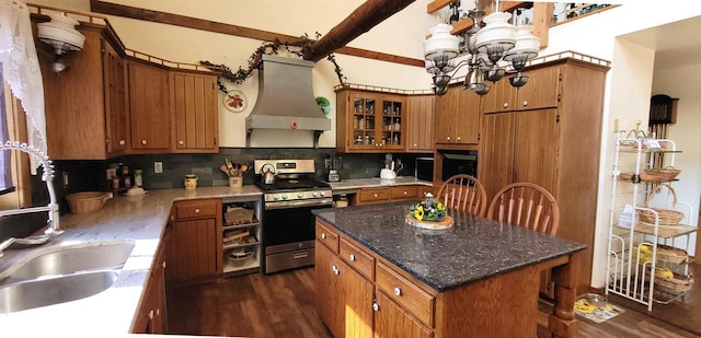 W6887 Two Mile Rd, Porterfield, WI 54159 - kitchen with stainless steel range with gas cooktop, premium range hood, a sink, brown cabinetry, and dark wood-style flooring