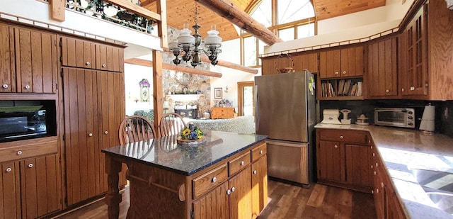 W6887 Two Mile Rd, Porterfield, WI 54159 - kitchen with freestanding refrigerator, a chandelier, dark wood-type flooring, high vaulted ceiling, and black microwave