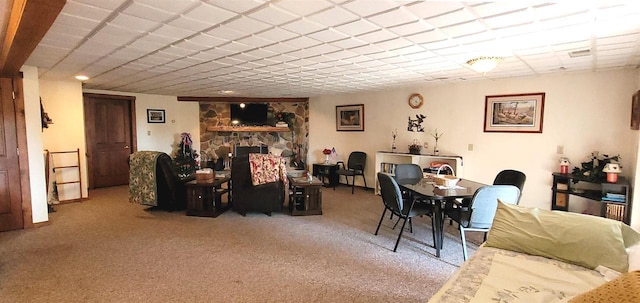 W6887 Two Mile Rd, Porterfield, WI 54159 - carpeted dining space with a stone fireplace and a paneled ceiling
