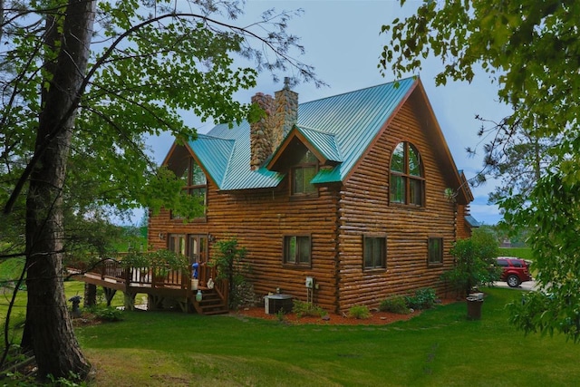 W6887 Two Mile Rd, Porterfield, WI 54159 - back of property with a deck, a chimney, a lawn, central AC unit, and metal roof