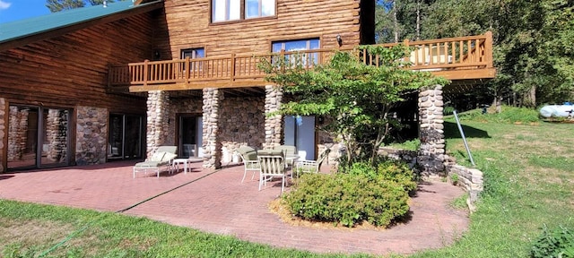 W6887 Two Mile Rd, Porterfield, WI 54159 - back of property featuring a patio area, a yard, stone siding, and a balcony