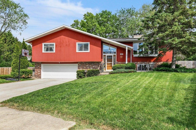 4917 Ralph Cir, Madison, WI 53714 - split foyer home with an attached garage, driveway, and brick siding