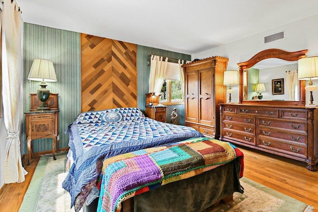 4917 Ralph Cir, Madison, WI 53714 - bedroom with light wood-style flooring, wood walls, and an accent wall
