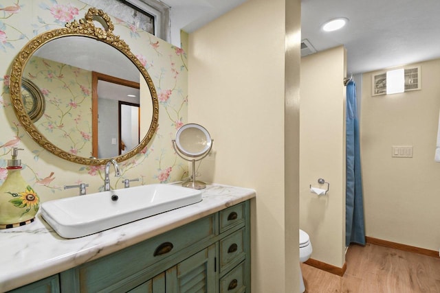 4917 Ralph Cir, Madison, WI 53714 - bathroom with toilet, wood finished floors, vanity, baseboards, and curtained shower