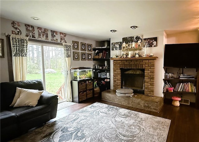 1051 E Chippewa Ave, Bruce, WI 54819 - living room with wood finished floors and a brick fireplace