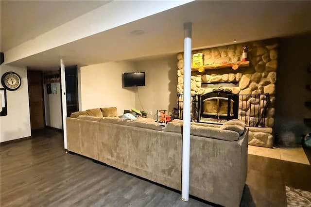 1051 E Chippewa Ave, Bruce, WI 54819 - living area featuring dark wood-style flooring and a stone fireplace