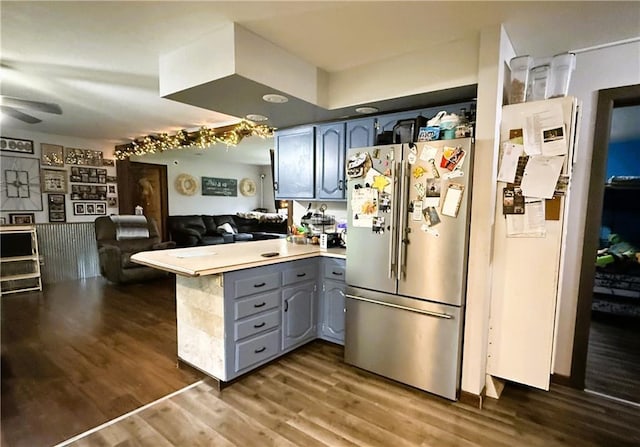 1051 E Chippewa Ave, Bruce, WI 54819 - kitchen featuring high quality fridge, a peninsula, gray cabinetry, dark wood-style floors, and light countertops