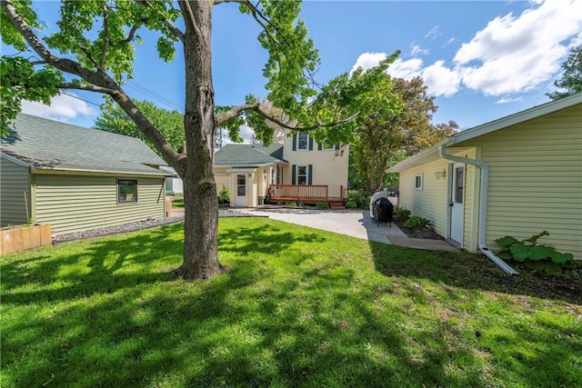 14 Chippewa St, Chippewa Falls, WI 54729 - view of grassy yard featuring a wooden deck and a patio