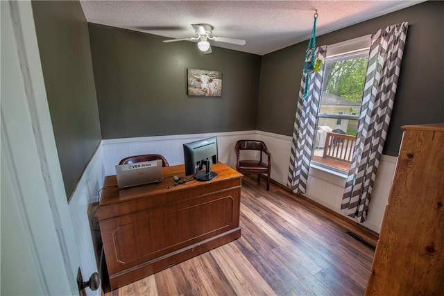 14 Chippewa St, Chippewa Falls, WI 54729 - office space featuring a textured ceiling, wainscoting, wood finished floors, and a ceiling fan