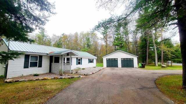 N18733 Short Cut Rd, Pembine, WI 54156 - single story home with an outbuilding, a garage, a porch, and metal roof