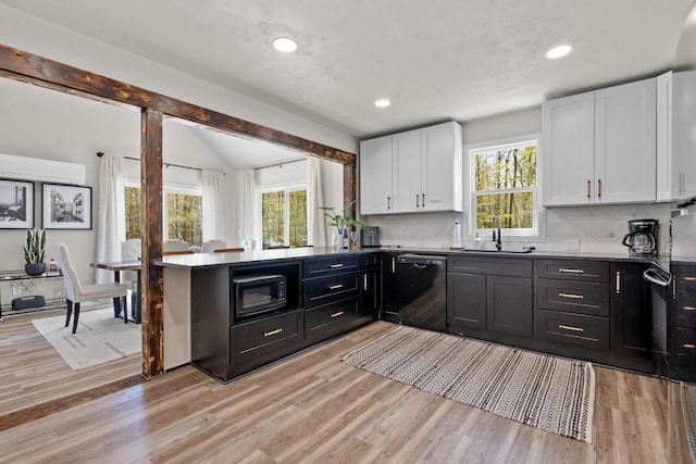 8606 State Highway 57, Baileys Harbor, WI 54202 - kitchen with black appliances, a sink, white cabinets, healthy amount of natural light, and recessed lighting