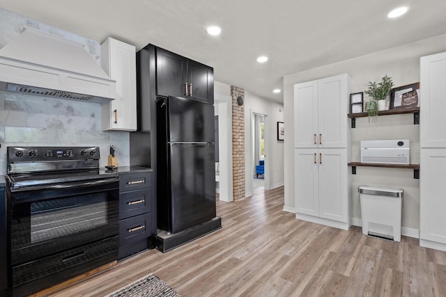 8606 State Highway 57, Baileys Harbor, WI 54202 - kitchen featuring black appliances, open shelves, custom exhaust hood, light wood-type flooring, and white cabinetry
