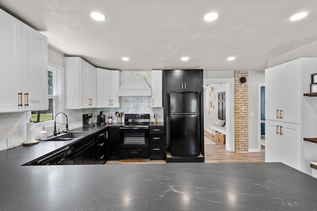 8606 State Highway 57, Baileys Harbor, WI 54202 - kitchen with black appliances, premium range hood, a sink, backsplash, and recessed lighting