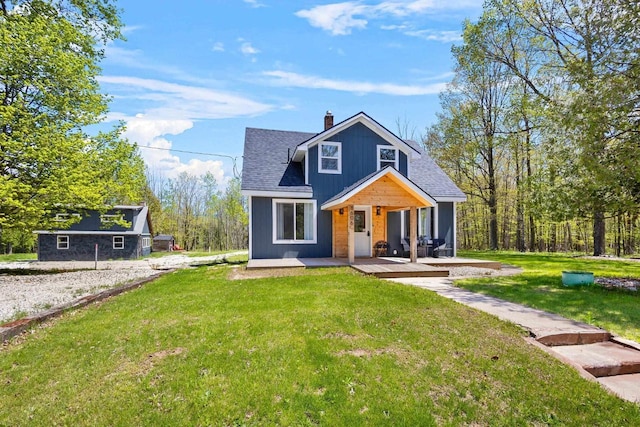 8606 State Highway 57, Baileys Harbor, WI 54202 - bungalow with a porch, a front lawn, a chimney, and roof with shingles
