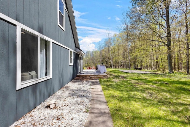8606 State Highway 57, Baileys Harbor, WI 54202 - view of property exterior with a lawn, a view of trees, and a wooden deck