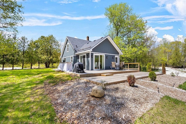8606 State Highway 57, Baileys Harbor, WI 54202 - back of property featuring a wooden deck, roof with shingles, a lawn, and a chimney