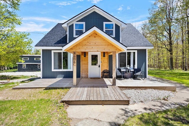 8606 State Highway 57, Baileys Harbor, WI 54202 - view of front facade with a shingled roof and a deck