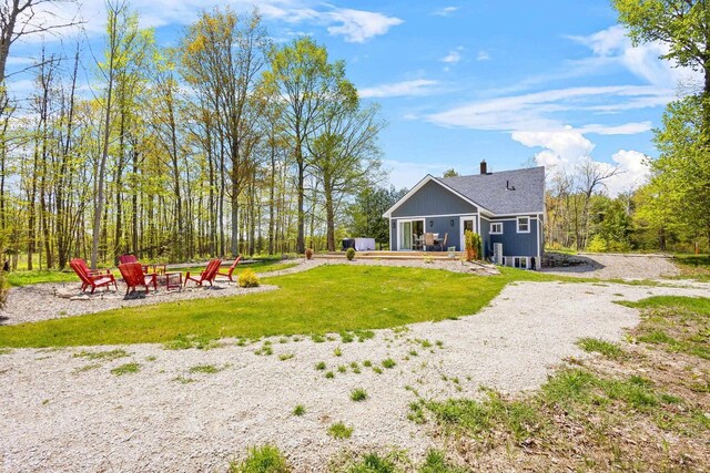 8606 State Highway 57, Baileys Harbor, WI 54202 - view of grassy yard with a fire pit