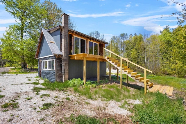 8606 State Highway 57, Baileys Harbor, WI 54202 - rear view of property featuring stairway, a wooden deck, and a chimney