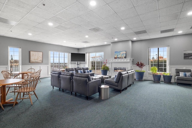 333 Lake Ave Unit 502, Racine, WI 53403 - living area with a glass covered fireplace, carpet floors, wainscoting, healthy amount of natural light, and a drop ceiling