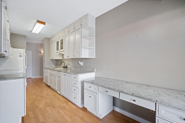 333 Lake Ave Unit 502, Racine, WI 53403 - kitchen featuring a sink, light wood finished floors, freestanding refrigerator, open shelves, and white cabinetry