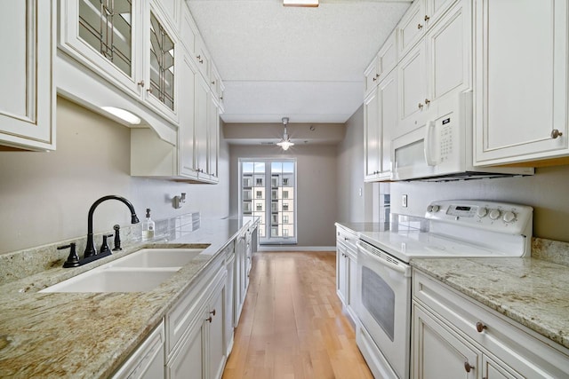 333 Lake Ave Unit 502, Racine, WI 53403 - kitchen featuring white appliances, a sink, a ceiling fan, light wood-style flooring, and white cabinetry