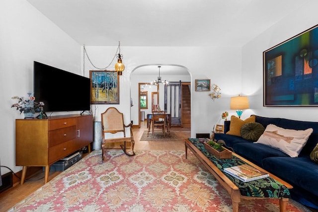 302 River Hts, Shawano, WI 54166 - living area with arched walkways, wood finished floors, and a chandelier