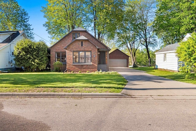 302 River Hts, Shawano, WI 54166 - bungalow with brick siding, a detached garage, an outbuilding, and a front lawn