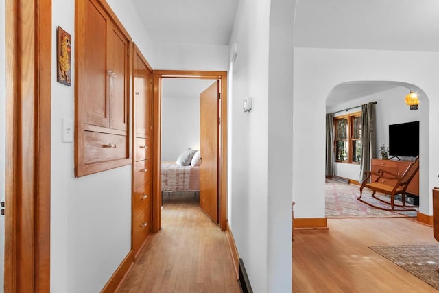 302 River Hts, Shawano, WI 54166 - hall featuring arched walkways, light wood-style floors, and baseboards