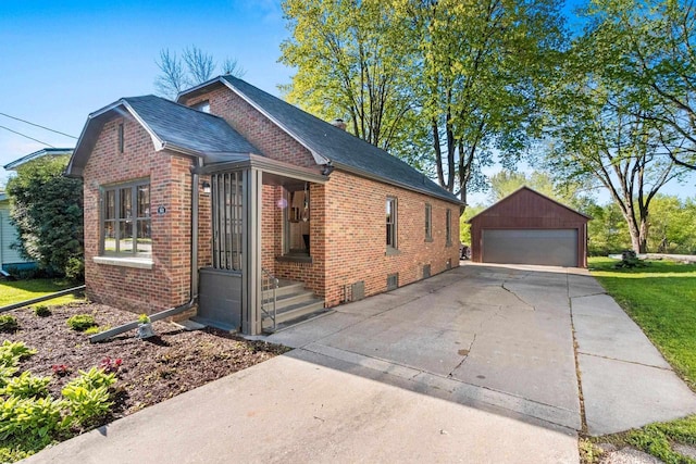 302 River Hts, Shawano, WI 54166 - view of side of property featuring brick siding, an outdoor structure, a detached garage, and a shingled roof