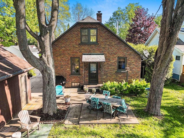 302 River Hts, Shawano, WI 54166 - rear view of property with a chimney, brick siding, and a patio area