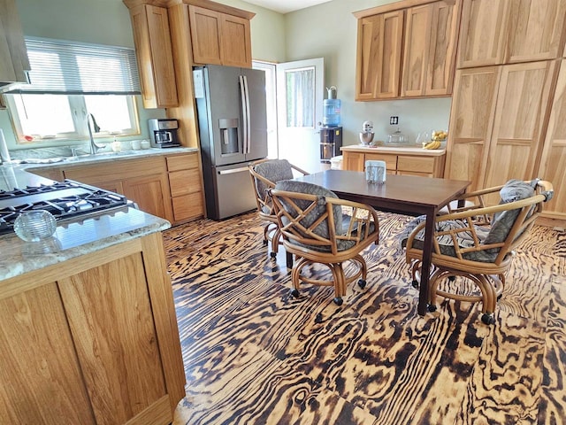 201 Center St, Elroy, WI 53929 - kitchen with stainless steel fridge with ice dispenser, a sink, and light brown cabinets