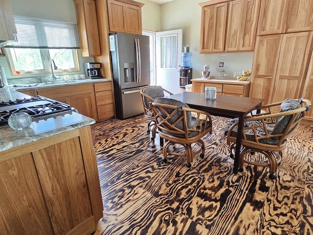 201 Center St, Elroy, WI 53929 - kitchen with stainless steel fridge, a sink, and stovetop