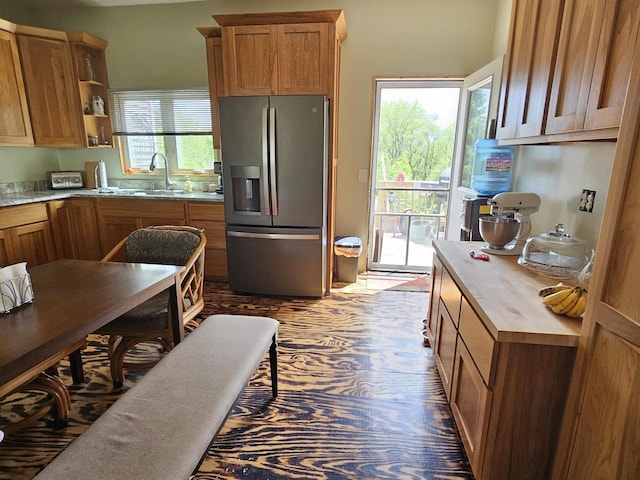 201 Center St, Elroy, WI 53929 - kitchen featuring stainless steel fridge, a sink, brown cabinetry, light countertops, and open shelves