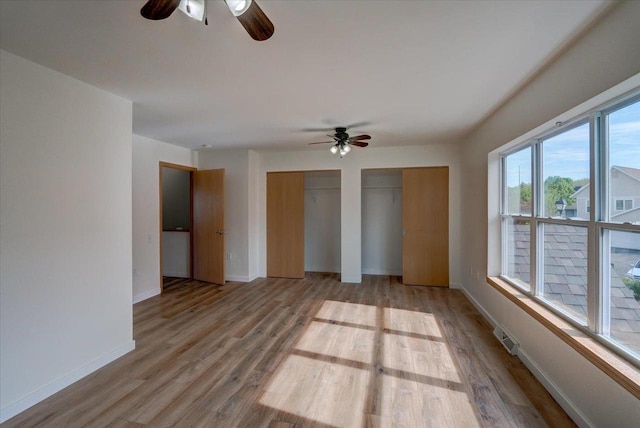 252 S Musket Ridge Dr Unit 2, Sun Prairie, WI 53590 - empty room with ceiling fan, wood finished floors, and baseboards