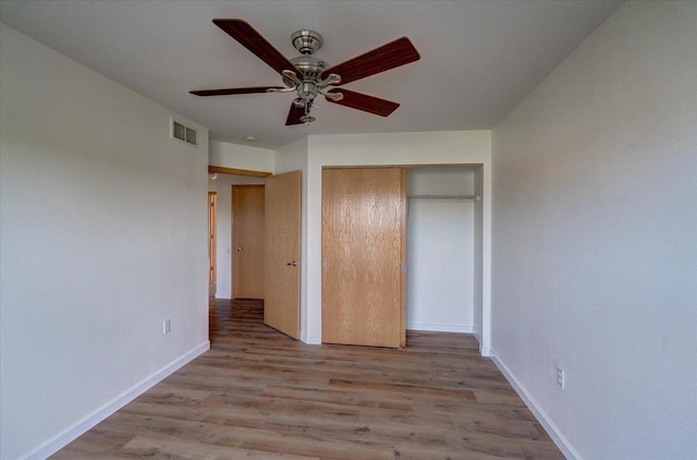 252 S Musket Ridge Dr Unit 2, Sun Prairie, WI 53590 - unfurnished bedroom featuring wood finished floors, baseboards, a closet, and a ceiling fan