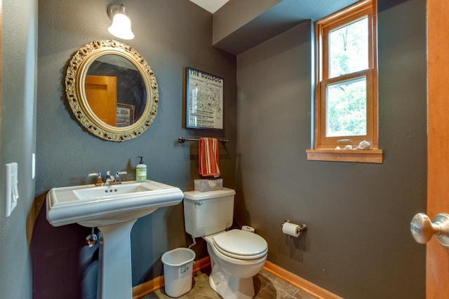 127 S Franklin St Unit 10, Madison, WI 53703 - half bath featuring toilet, baseboards, and tile patterned flooring