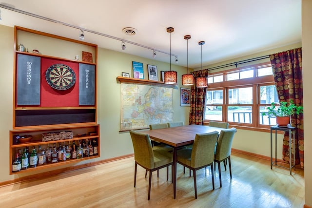127 S Franklin St Unit 10, Madison, WI 53703 - dining area featuring rail lighting, wood finished floors, and baseboards