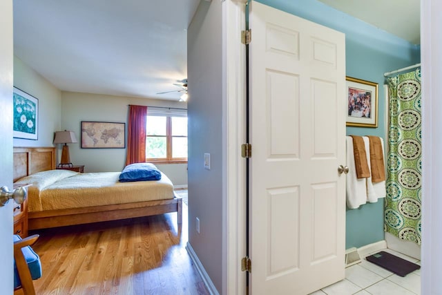 127 S Franklin St Unit 10, Madison, WI 53703 - bedroom with baseboards, light wood-type flooring, and ceiling fan