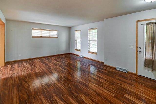 9305 Briar Haven Dr, Verona, WI 53593 - empty room featuring wood finished floors, plenty of natural light, and baseboards