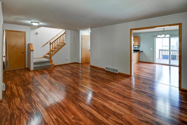 9305 Briar Haven Dr, Verona, WI 53593 - unfurnished living room featuring wood finished floors, stairway, baseboards, and a chandelier