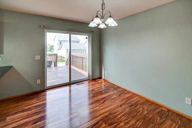 9305 Briar Haven Dr, Verona, WI 53593 - unfurnished room featuring a chandelier, wood finished floors, and baseboards