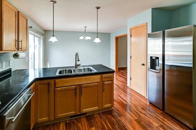9305 Briar Haven Dr, Verona, WI 53593 - kitchen featuring appliances with stainless steel finishes, a sink, dark wood-style floors, and brown cabinets