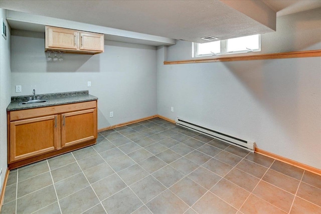 9305 Briar Haven Dr, Verona, WI 53593 - below grade area with a baseboard radiator, a sink, and baseboards