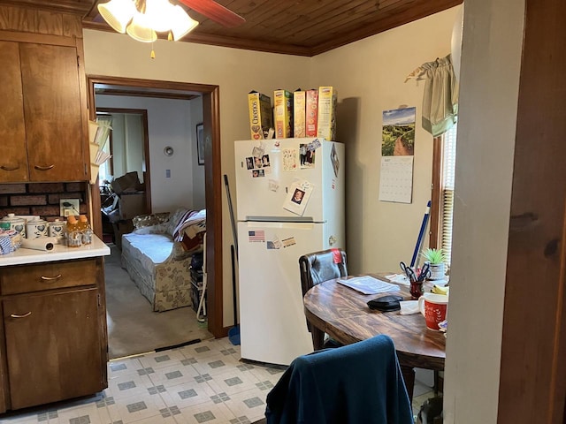397 W Division St, Fond Du Lac, WI 54935 - kitchen featuring freestanding refrigerator, wooden ceiling, light countertops, crown molding, and ceiling fan