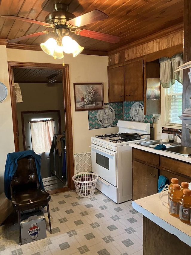 397 W Division St, Fond Du Lac, WI 54935 - kitchen with wooden ceiling, white range with gas cooktop, a sink, ceiling fan, and light countertops