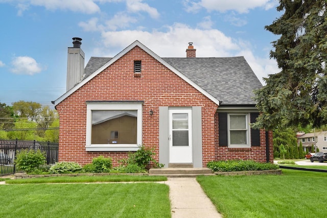 10339 W Hampton Ave, Milwaukee, WI 53225 - view of front of home with a chimney, brick siding, and roof with shingles