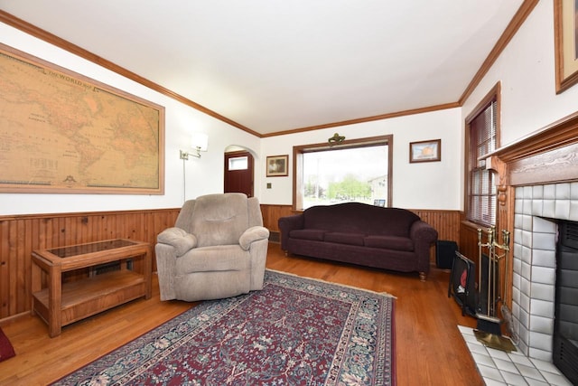 10339 W Hampton Ave, Milwaukee, WI 53225 - living room with wainscoting, wood walls, wood finished floors, a fireplace, and crown molding