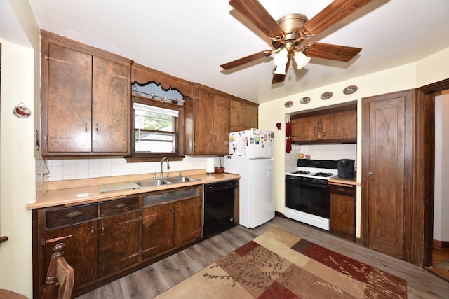 10339 W Hampton Ave, Milwaukee, WI 53225 - kitchen with range with gas stovetop, dishwasher, freestanding refrigerator, dark wood-style floors, and tasteful backsplash